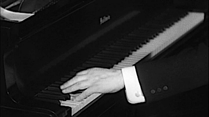 A pianist's left hand on the piano. Black and White.